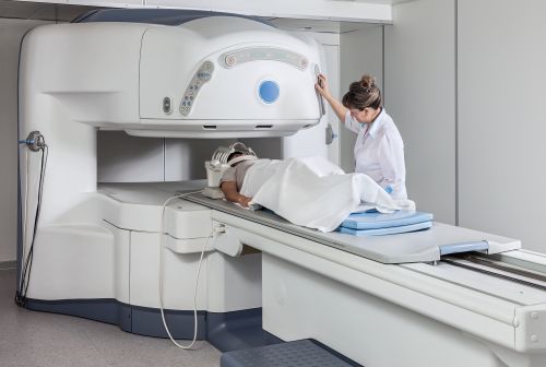 A hospital patient on a table with a doctor looking at him