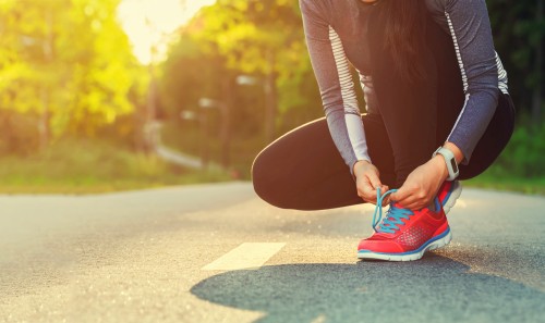 Woman tying her running shoes